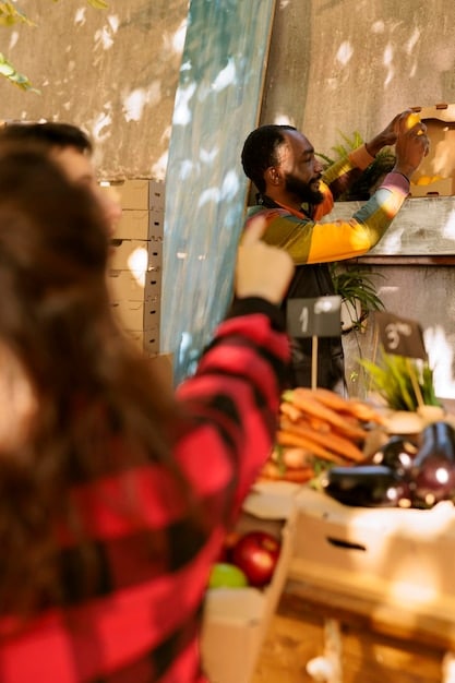 A photograph capturing a scene inside a food bank or distribution center. Volunteers are actively sorting, organizing, and packing donated food items into boxes or bags for distribution to families in need. The setting should appear organized and clean, with shelves stocked with food and individuals working collaboratively to ensure efficient and equitable distribution.