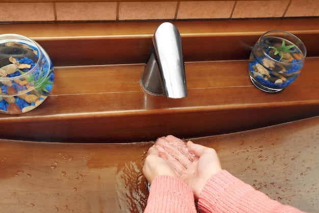 A close-up shot of a hand turning on a newly installed water tap in a rural home, with clean, clear water flowing out. The background is slightly blurred, focusing on the water and the hand.