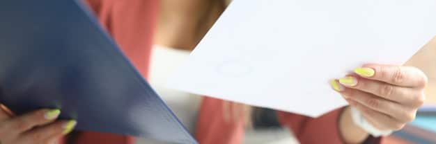 Detailed close-up of an open edital document, emphasizing the importance of reviewing the terms and conditions, with blurred figures in the background representing community members.