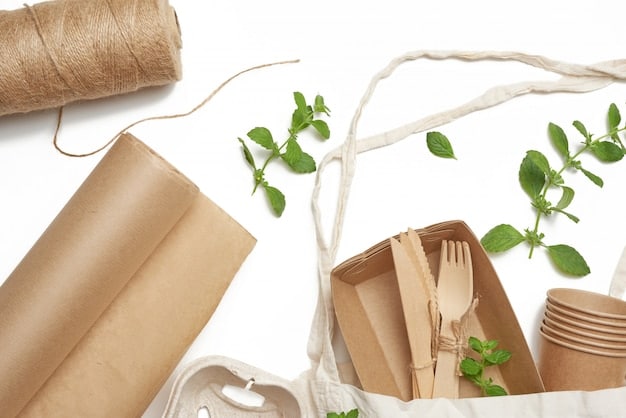 Eco-friendly packaging materials. Close-up of various biodegradable packaging options, including paper bags, cardboard boxes, and compostable containers, showcasing their textures and natural colors.