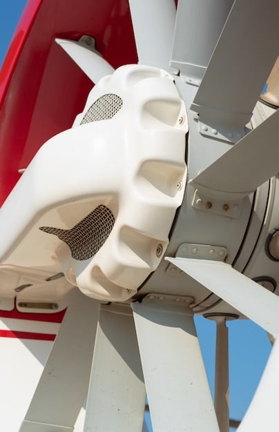 A detailed, angled shot of the interior of a wind turbine nacelle, showing the generator, gearbox, and other mechanical components, with an engineer inspecting the equipment. The light should be bright, emphasizing the complexity and scale of the machinery.