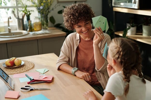 A young woman sitting at a table, helping a child with their homework, both smiling and engaged in the activity.
